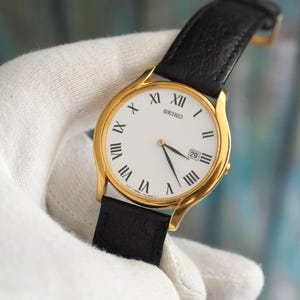 Seiko 7N29-8A80 Classic Gold-Tone Quartz Watch – 35mm Case, Roman Dial, Black Strap, Minimalist Vintage Style