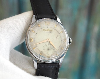 Reloj Omikron vintage de los años 50: 36 mm, mecánico de cuerda, 21 joyas, clásico reloj de pulsera para hombre de mediados de siglo.
