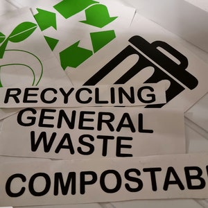 May include: Three white labels with black text and green and black icons. The labels read "RECYCLING", "GENERAL WASTE", and "COMPOSTABLE".