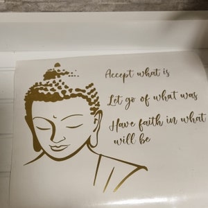 May include: A gold silhouette of Buddha with the quote "Accept what is, Let go of what was, Have faith in what will be".