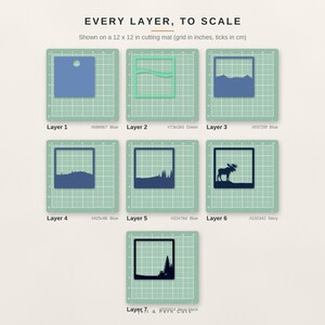 May include: Seven square layered paper cutouts displayed on a 12 x 12 inch cutting mat. The layers feature various blue and green shades, depicting a landscape with mountains, trees, and a moose silhouette, labeled Layer 1 through Layer 7.