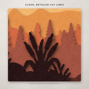 May include: A multi-layered paper art design featuring a dark brown foreground of cattails and foliage, set against silhouettes of pine trees and rolling hills in shades of orange and rust. The text CLEAN, DETAILED CUT LINES appears above.