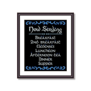 May include: A black and white cross-stitch design with blue accents. The design reads "Now Serving" with a list of meal times: Breakfast, 2nd Breakfast, Elevenses, Luncheon, Afternoon Tea, Dinner, Supper.