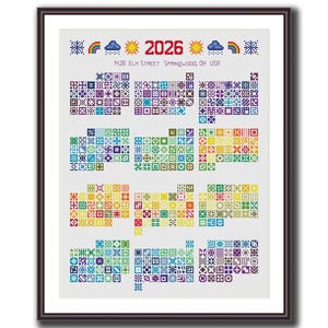 May include: Framed cross-stitch sampler with the year "2026" and address "1428 ELM STREET Springwood, OH USA" at the top. The sampler features a grid of colourful geometric patterns in various colours, including blue, green, yellow, and purple.
