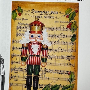 May include: A painted image of a Nutcracker soldier from the ballet "Casse-Noisette" on a musical score background. The Nutcracker is in a red and white striped uniform with green accents. The image includes text: "Patterns by Carolyn" and "Acrylics."