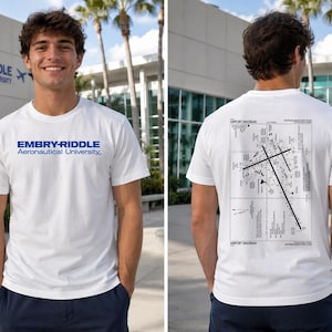 May include: A white short-sleeve t-shirt featuring the blue text EMBRY-RIDDLE Aeronautical University on the front chest and a detailed black and white airport diagram graphic printed on the back of the garment.