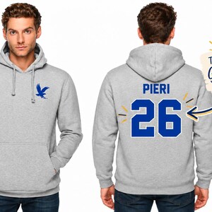 May include: A light gray hooded sweatshirt featuring a blue eagle logo on the front left chest. The back displays the name PIERI above the large blue number 26. A graphic note points to the number with the text The 26 is your Graduation Year.