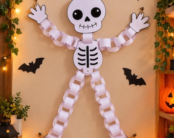 Könnte beinhalten: Eine Skelett-Dekoration aus weißem Papier mit einem großen Schädel, schwarzen Augen und einem aufgemalten Mund, einem Brustkorb-Torso sowie Gliedmaßen aus ineinandergreifenden weißen Papierschlaufen, ergänzt durch flache Hände und Füße.