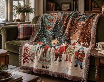 May include: A woven throw blanket featuring a festive scene of figures in winter clothing standing under a large decorated Christmas tree with stars, rendered in shades of green, red, brown, and cream with a fringed edge.