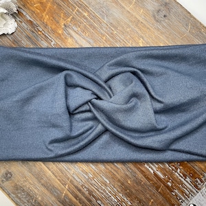 May include: A dark blue stretchy headband with a twisted knot design.