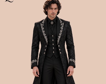 May include: A black long coat featuring a subtle tonal damask pattern, silver floral embroidery along the lapels and cuffs, and a matching black vest with silver buttons. The ensemble includes a black shirt with a silver brooch at the collar.