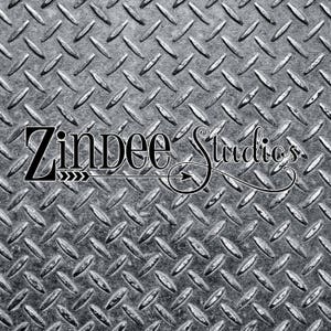 May include: A black and white image of a metal diamond plate background with the text "Zindee Studios" in a stylized font with an arrow pointing to the right.