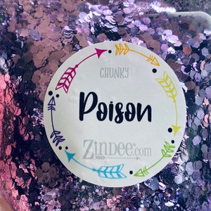 May include: A white round sticker with a purple, yellow, and blue arrow design. The sticker says "CHUNKY Poison Zindee.com".