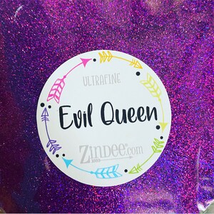 May include: Purple ultra-fine glitter with a white circle label that says "Evil Queen" and "Zindee.com" with arrows around the text.