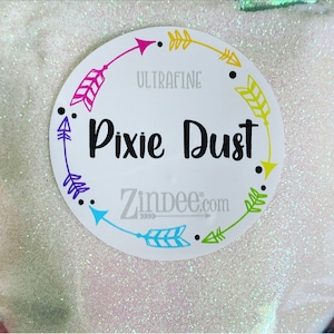 May include: White glitter with a white circle label that says "Ultrafine Pixie Dust Zindee.com" with colorful arrows around the edge.