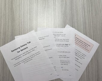 May include: A stack of white printed instructional pages titled Samsung Galaxy Tab for Seniors. The text provides a big-print guide for video calls, YouTube, email, and reading, with instructions on using the tablet interface and security tips.