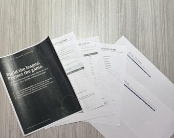 May include: A stack of printed documents featuring a black cover page with the white text Build the league. Protect the game. and additional pages with tables and lists, accompanied by a pair of black-rimmed eyeglasses resting nearby.