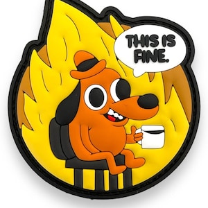May include: A circular rubber patch featuring an orange cartoon dog wearing a hat, sitting on a chair amidst yellow flames. The dog holds a white mug, and a white speech bubble above contains the black text THIS IS FINE.