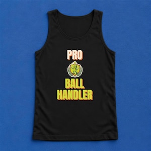 May include: A black tank top featuring the text PRO BALL HANDLER in yellow and orange block letters. Between the words PRO and BALL is a circular emblem with a green border, depicting a cartoon character juggling three yellow balls.