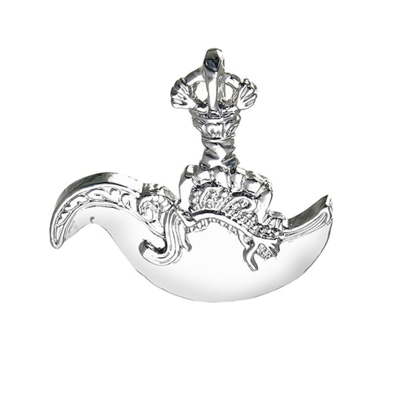 May include: A silver pendant in the shape of a crescent moon with a crown on top. The moon is decorated with intricate details and the crown is adorned with a floral design.
