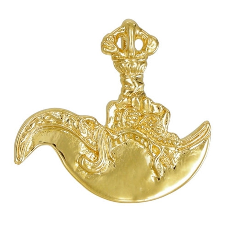 May include: A gold-colored metal pendant in the shape of a crescent moon with a crown on top. The pendant is highly detailed with intricate carvings.