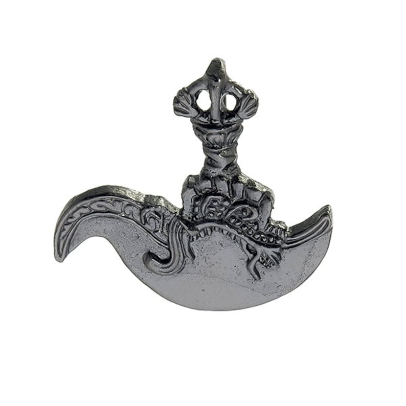 May include: A silver-colored metal pendant in the shape of a crescent moon with a decorative design. The pendant has a small, ornate finial on top.