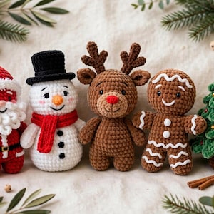 May include: A set of five crocheted holiday figures including a red and white Santa Claus, a white snowman with a black hat and red scarf, a brown reindeer with a red nose, a brown gingerbread person, and a green Christmas tree.