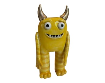 Cute yellow stripe monster tall cute monster sculpture gold horns