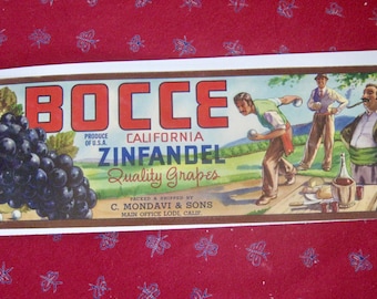 May include: Vintage rectangular sign featuring the word "BOCCE" in large red letters. The sign promotes California Zinfandel grapes, with illustrations of grapes and men playing bocce ball. The sign is from C. Mondavi & Sons.