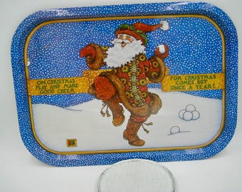 May include: A rectangular Christmas serving tray with a blue border and a festive Santa Claus illustration. The image includes text that reads "ON CHRISTMAS PLAY AND MAKE GOOD CHEER" and "FOR CHRISTMAS COMES BUT ONCE A YEAR!"