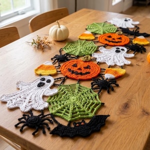 May include: A Halloween-themed crochet table runner featuring interconnected motifs of white ghosts, orange jack-o'-lanterns, green spider webs, black spiders, black bats, and yellow, orange, and white candy corn shapes.