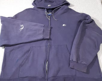 May include: A dark blue zip-up hooded sweatshirt featuring a white Starter logo on the left chest and the hood. The garment includes a full-length front zipper, two front pockets, and a white paint-like stain on the right sleeve.