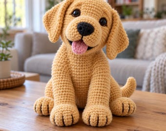 May include: A golden-yellow crochet puppy toy with large dark eyes, a black nose, and a small pink tongue sticking out. The stuffed animal features floppy ears, a textured yarn surface, and visible paw details on its front feet.