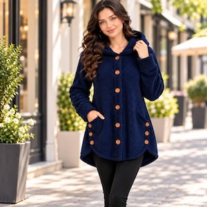 May include: A navy blue hooded jacket made of a textured fleece material. The jacket features a front button closure with light brown buttons, long sleeves, and two front pockets, each accented with three matching light brown buttons.