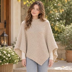 May include: A beige knit poncho featuring a ribbed mock neck collar and ribbed trim along the hem. The garment has a textured, chunky knit construction with a pointed, asymmetrical hemline that drapes over the shoulders and arms.
