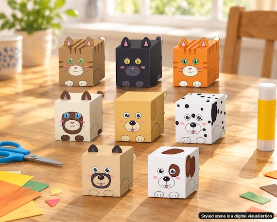 Visualisation of nine finished 3D paper box cats and dogs from the printable bundle, on a table indoors