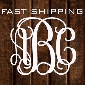May include: White monogram with the letters "JBC" in a script font, against a woodgrain background. The letters are intertwined and the "B" is in the center.