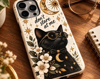 May include: A cream-colored phone case featuring a black cat wearing round glasses and a bow tie with a crescent moon charm. The design includes white flowers, gold stars, a crescent moon, and the text "don't stare at me" in black script.