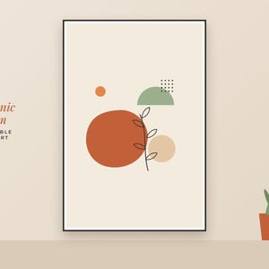 May include: A framed wall art print titled Organic Bloom featuring a cream background with a large terracotta circle, a smaller beige circle, a sage green semicircle, a small orange dot, a grid of dots, and a black line drawing of a plant stem.