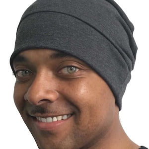 May include: A dark gray beanie with a folded cuff. The beanie is made of a soft, stretchy fabric.