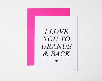 May include: A white card with a pink border. The card has black text that reads "I love you to Uranus & back" with a small black heart at the bottom.