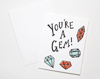 May include: A white card with black text that reads "You're a Gem!" and four colorful gem illustrations.