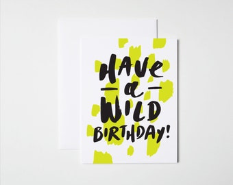May include: A white card with yellow splotches and black text that reads "Have a Wild Birthday!"