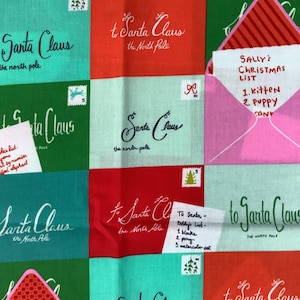 May include: A colorful fabric with a repeating pattern of envelopes addressed to Santa Claus. The envelopes have different colored backgrounds and feature handwritten text, including a Christmas list with items like a kitten and a puppy.