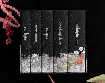 May include: A set of five books in a black box, each spine featuring a black background with white speckles, white text titles, and a base illustration of flowers. The titles are Twilight, New Moon, Eclipse, Breaking Dawn, and Midnight Sun.