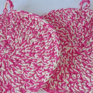 May include: Two pink and white crocheted pot holders with a loop handle.