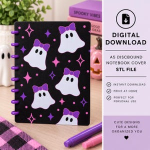 May include: A black A5 discbound notebook cover featuring a repeating pattern of white ghosts wearing purple bows, accented with pink and purple four-pointed stars and small dots. The cover has a series of purple discs along the left edge.
