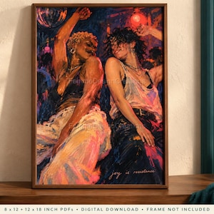May include: A framed art print depicting two individuals dancing in a vibrant, colorful nightclub setting. The painting features expressive brushstrokes, warm lighting, and the text 'joy is resistance' at the bottom. The print is displayed in a wooden frame.