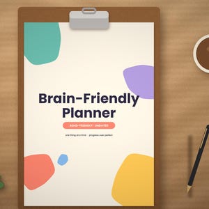 May include: A clipboard holding a paper titled Brain-Friendly Planner with the text ADHD-FRIENDLY UNDATED and one thing at a time progress over perfect. The page features abstract teal, purple, coral, blue, and yellow shapes.