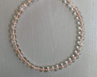 round clear quartz necklace on orange cord / large, smooth